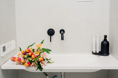 a bathroom sink with a bunch of flowers on it