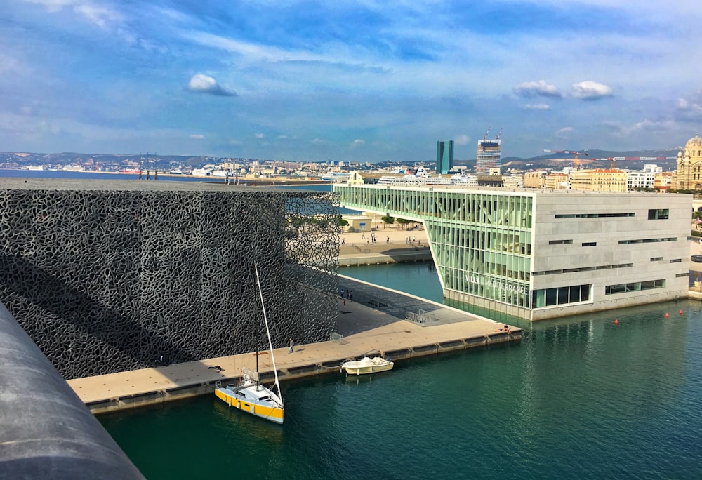 a boat is docked in the water next to a building