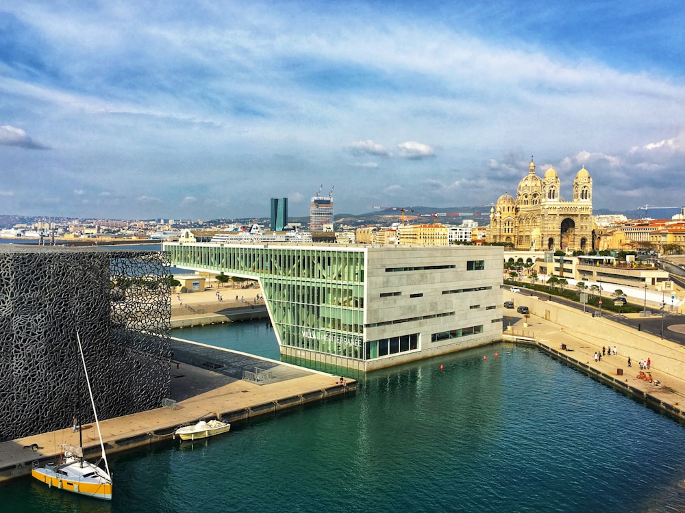 a view of a large building next to a body of water