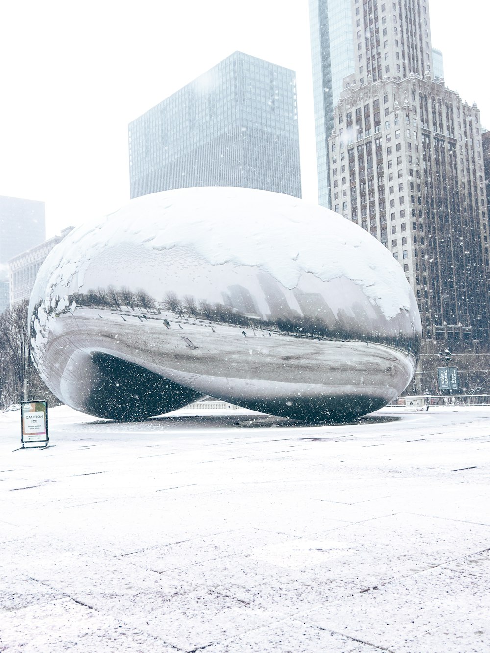 a large white object sitting in the middle of a snow covered field
