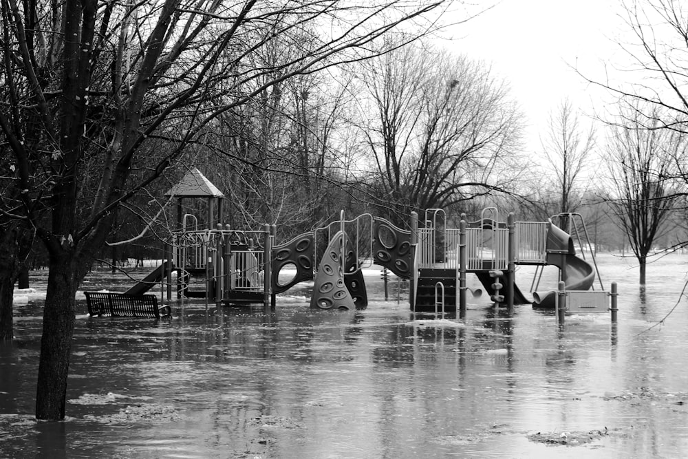 a playground is flooded with water and trees