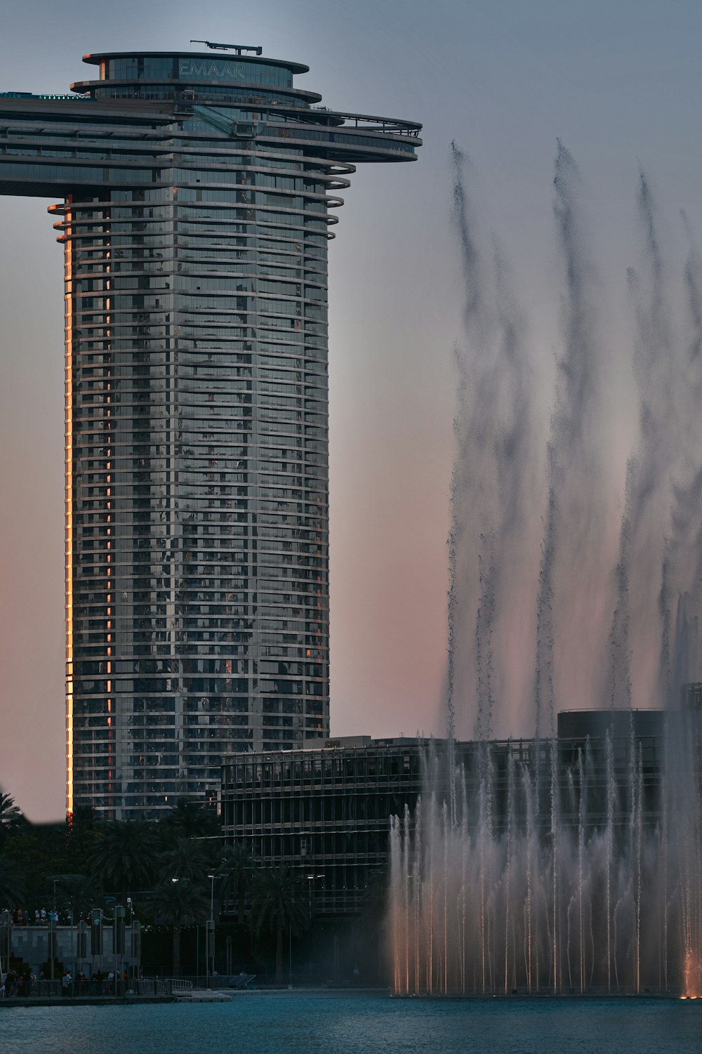 a very tall building with a lot of water shooting out of it