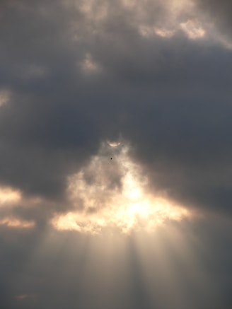 the sun is shining through the clouds in the sky