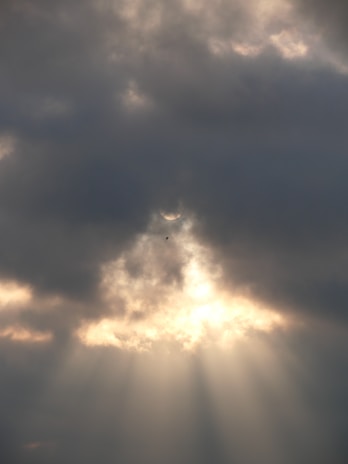 the sun is shining through the clouds in the sky