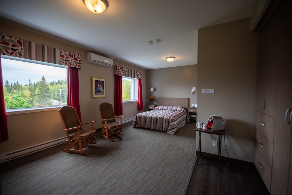 a bedroom with a rocking chair and a bed