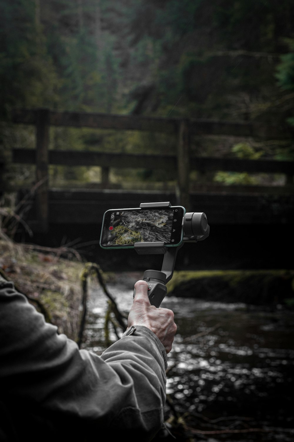 a person taking a picture of a river with a camera