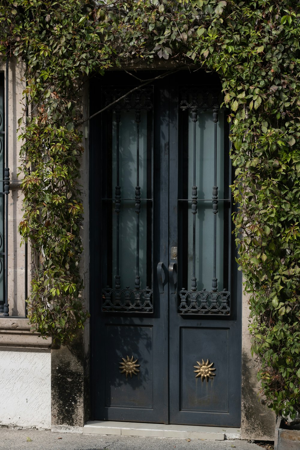a black door with a sun decoration on it