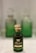 A green glass bottle of Marsoom Fragrance No. 2 with an ornate gold cap is prominently displayed. Behind it, two similar bottles are blurred, creating a sense of depth.