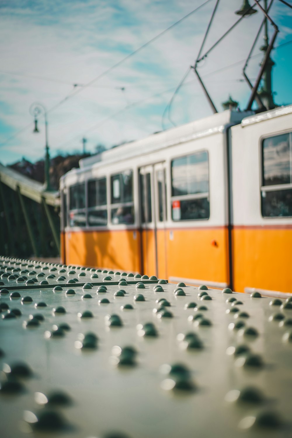 an orange and white train traveling down train tracks