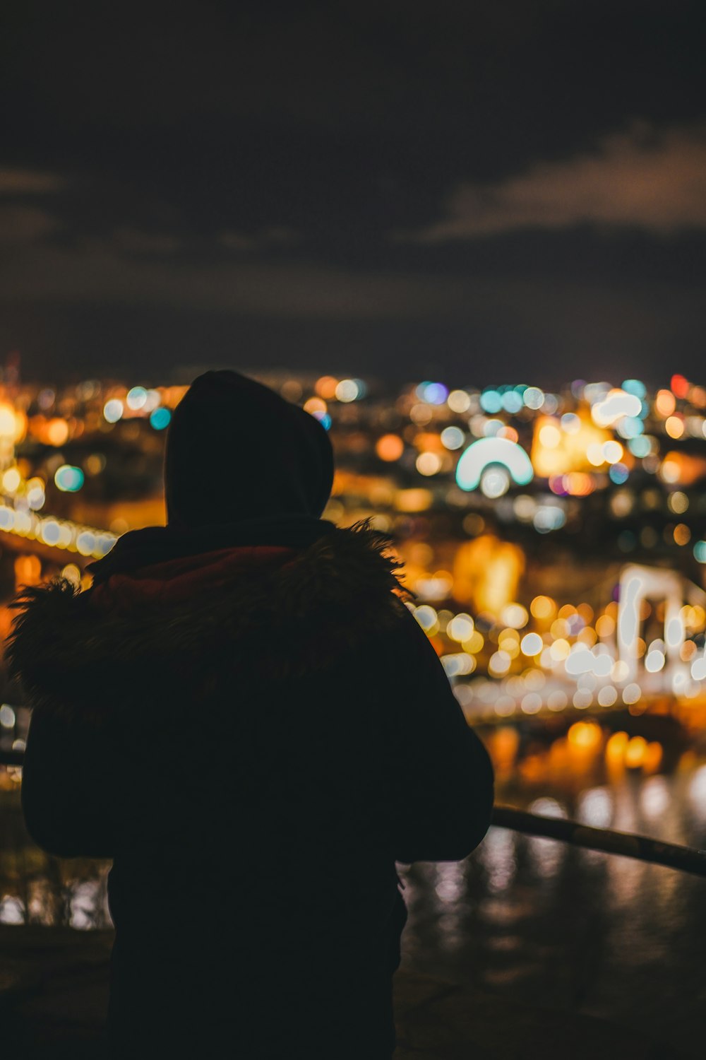 a person looking out over a city at night