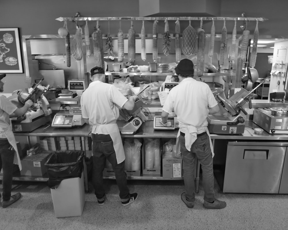 a group of people preparing food in a kitchen