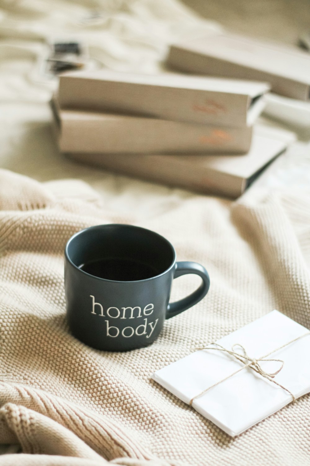 a cup of coffee sitting on top of a bed