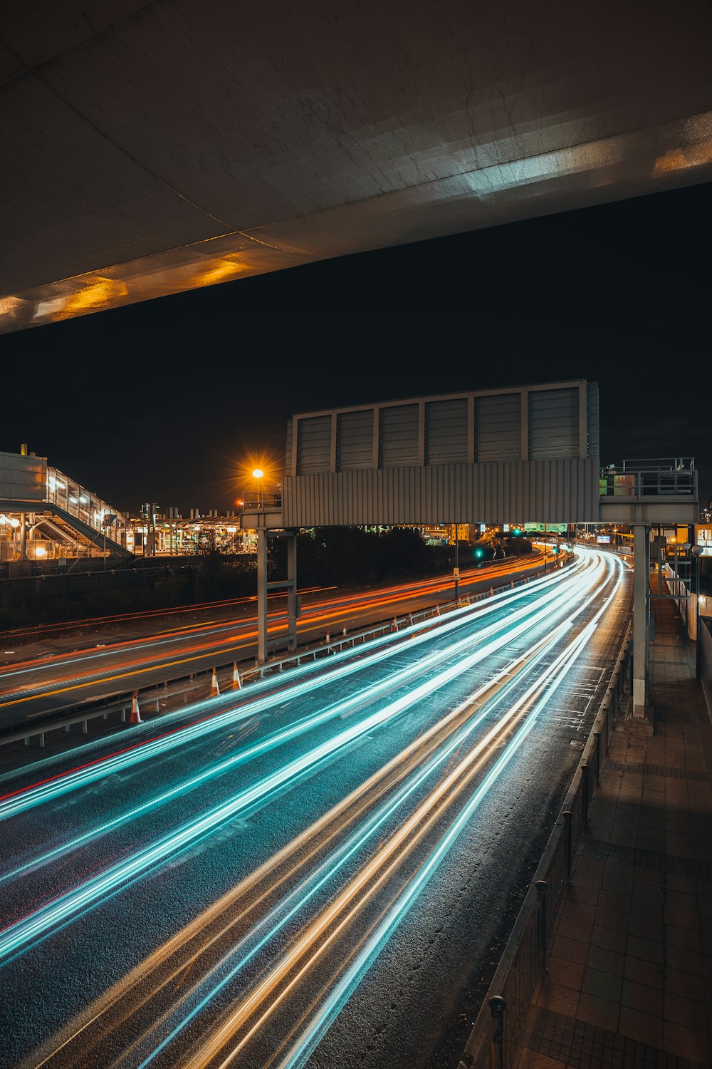 a long exposure photo of a highway at night