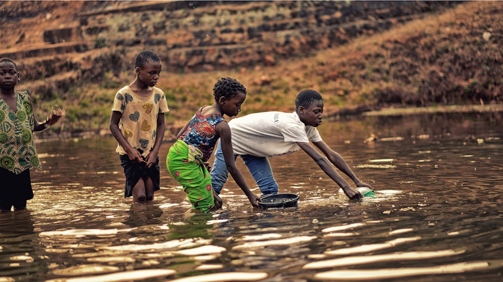 a group of children playing in a body of water