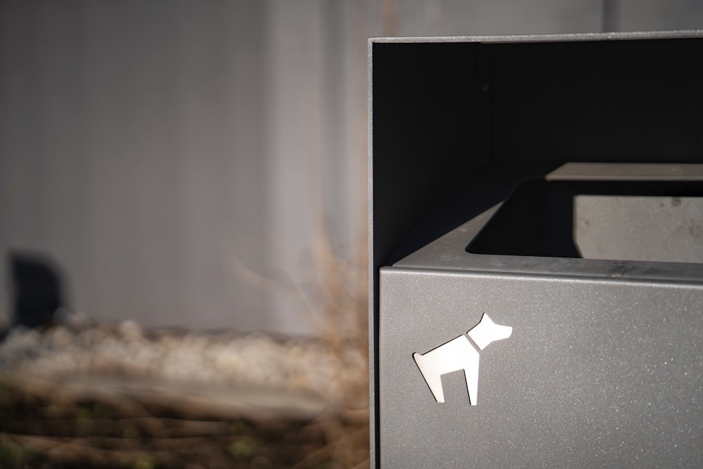 a close up of a metal box with a dog sticker on it