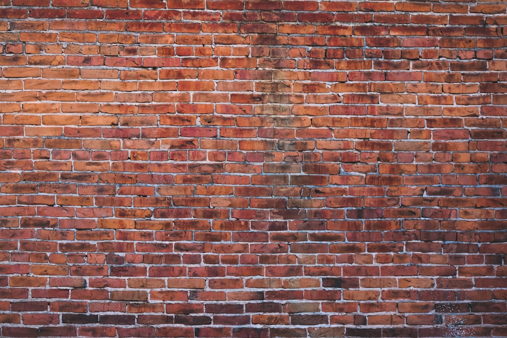 a red brick wall with a white fire hydrant