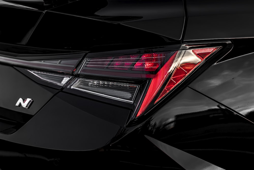 a close up of the tail lights of a black car