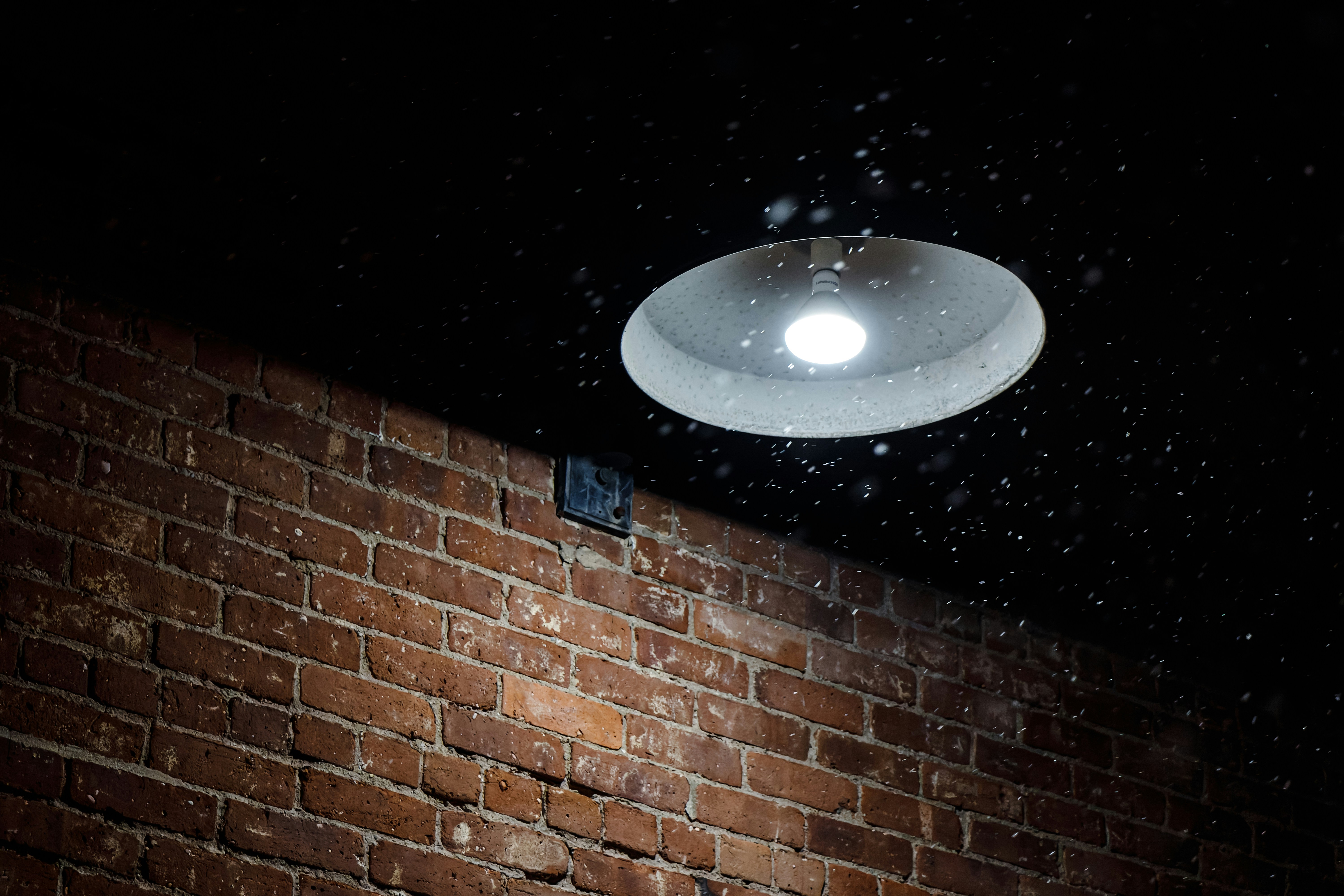 A brick wall with a street light on top of it photo – Free Lighting ...