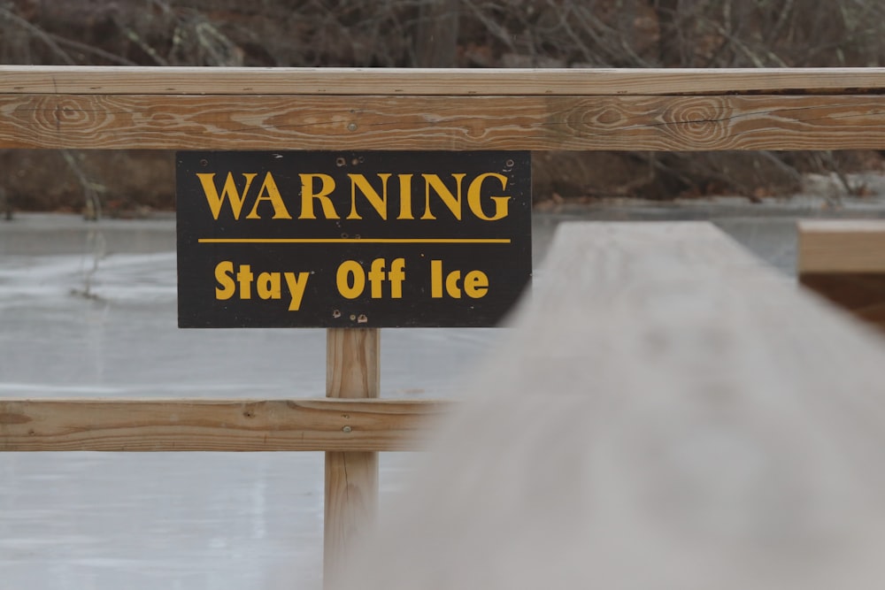 a sign warning of stay off ice on a bridge