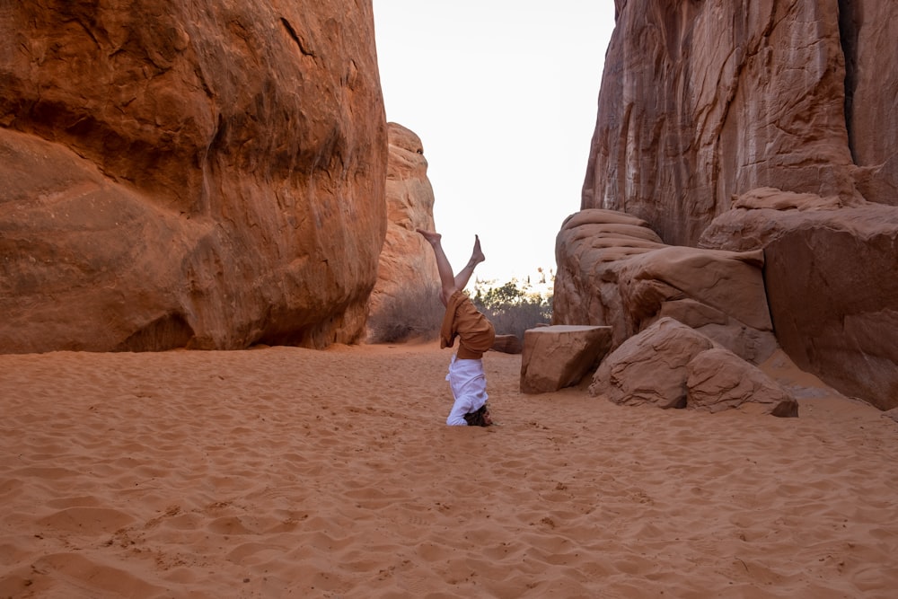 a person standing on top of a sandy beach