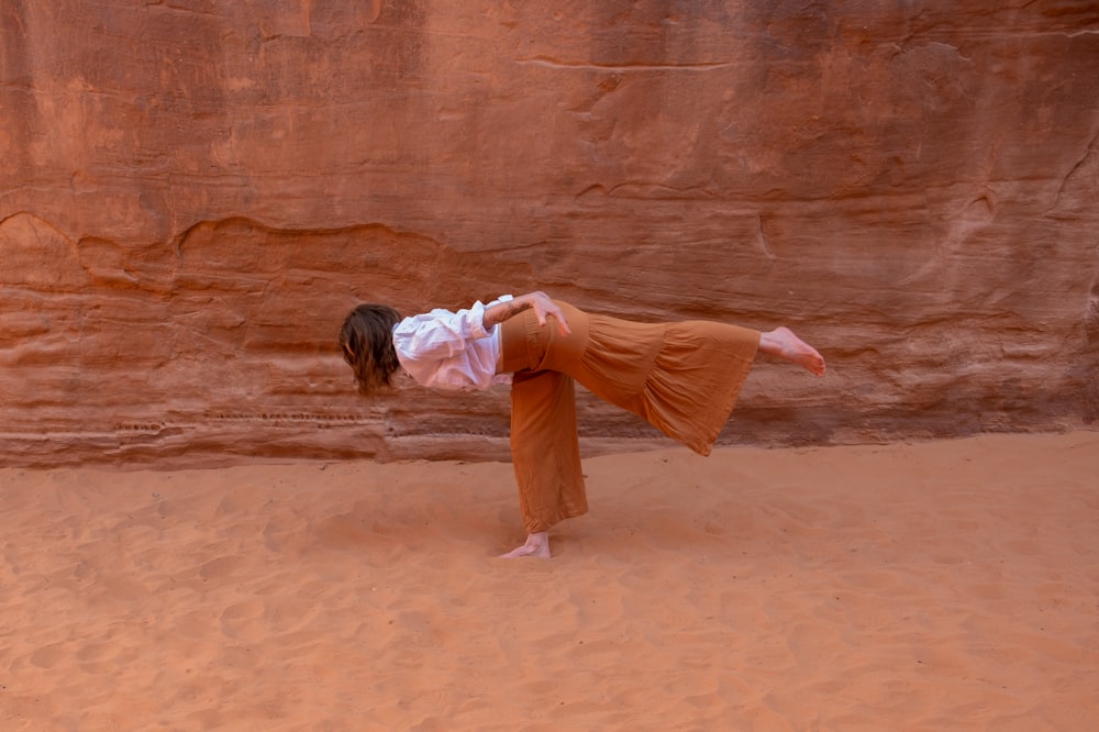 a woman doing a handstand in the desert