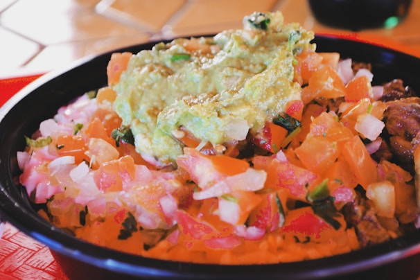A colorful bowl of quick avocado and black bean salad fresh from the kitchen