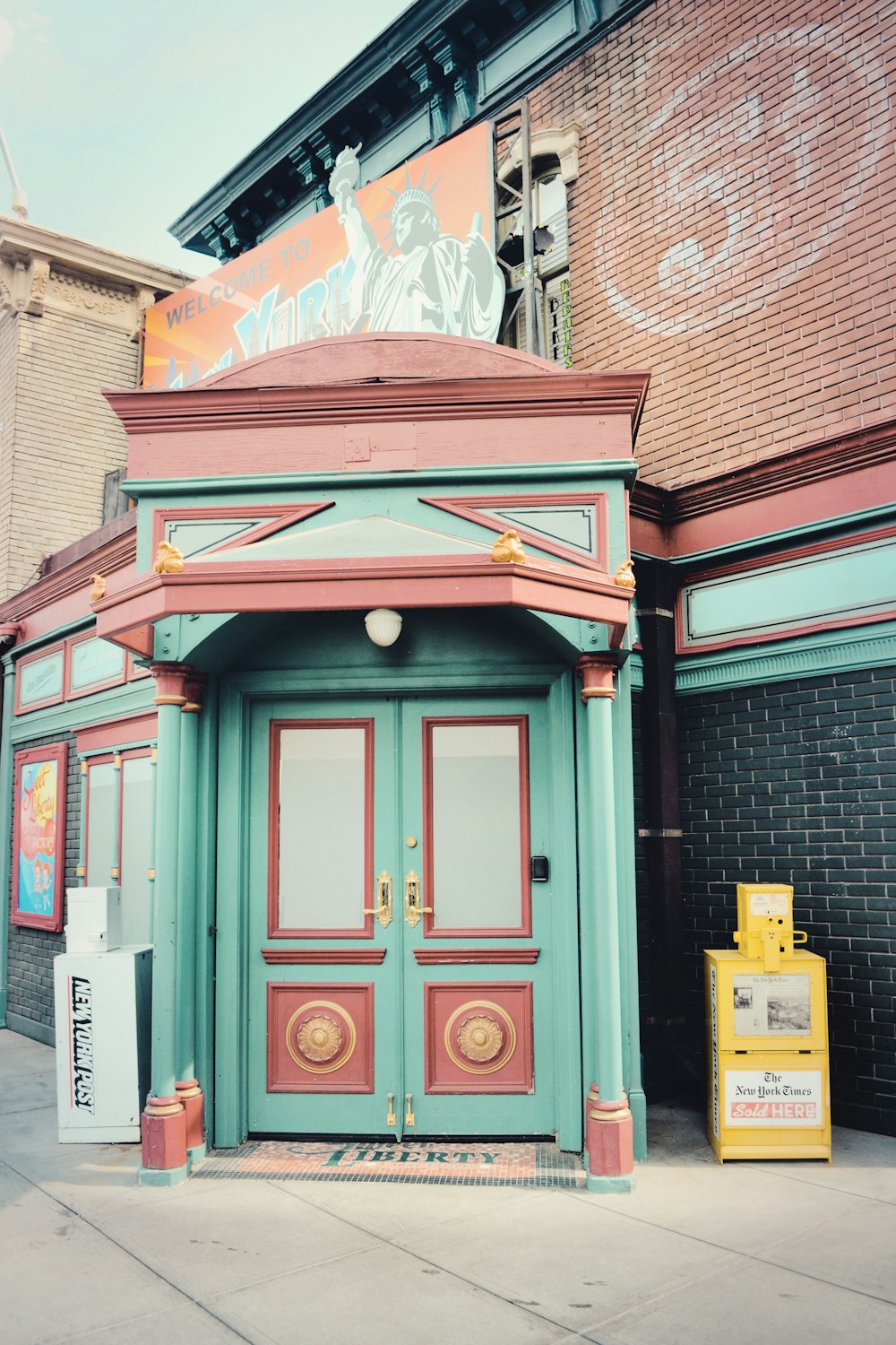 a building with a green door and red trim