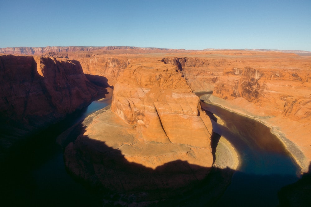 a river cuts through a canyon in the desert