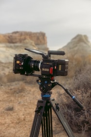 a video camera on a tripod in the desert