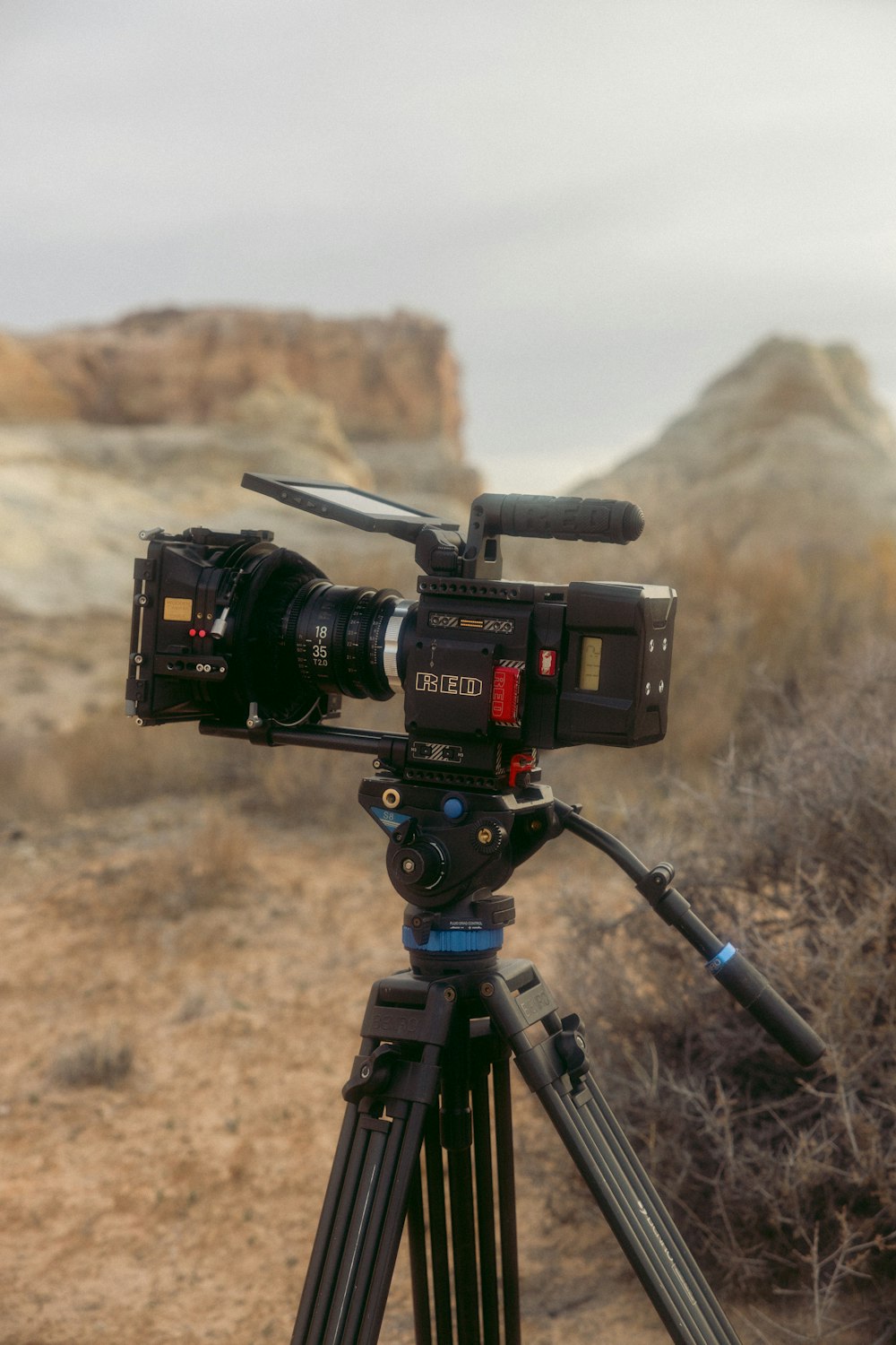 a video camera on a tripod in the desert
