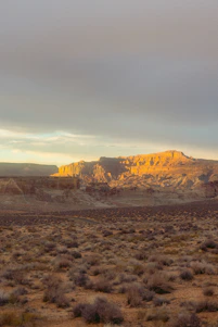 Sunset casting golden light over a quiet Arizona mining town nestled in the desert.