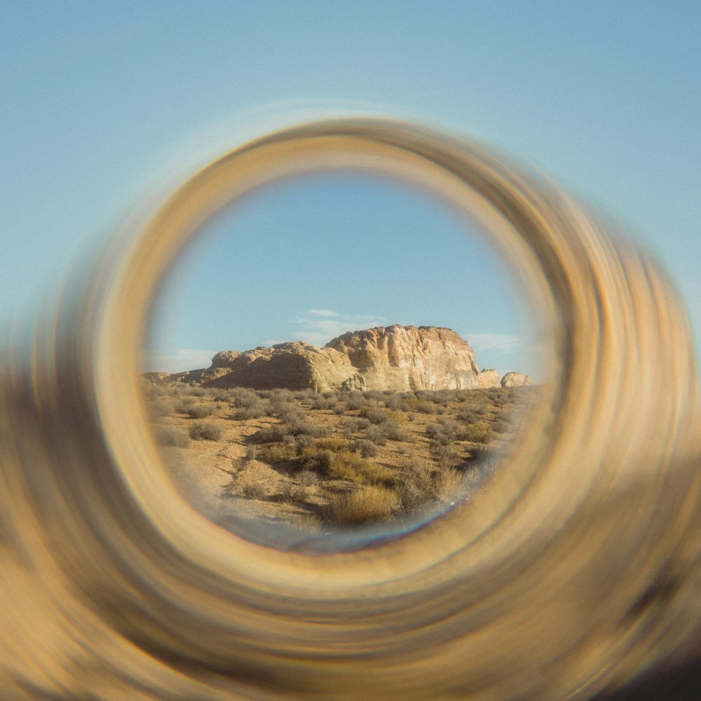 a blurry photo of a desert with a mountain in the background