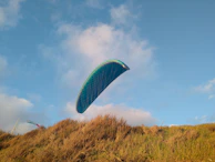 A smiling local family watching the sky as a paramotor flies overhead, symbolizing connection.