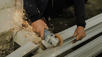 a man using a grinder on a piece of metal