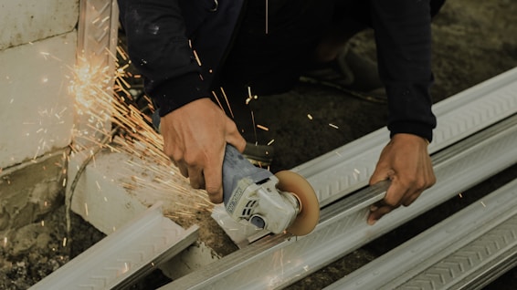 a man using a grinder on a piece of metal