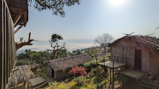 A scenic view of the Ethiopian landscape with traditional huts in the foreground.