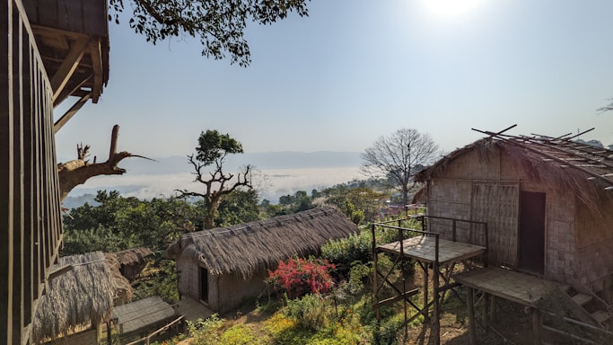 A scenic view of the Ethiopian landscape with traditional huts in the foreground.