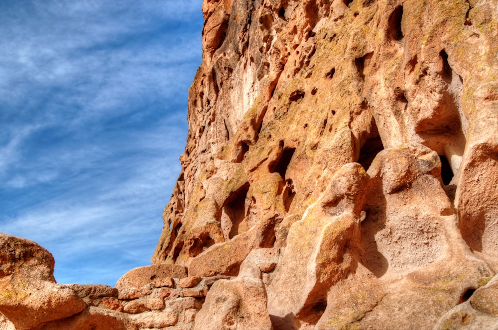 a large rock formation with a sky in the background