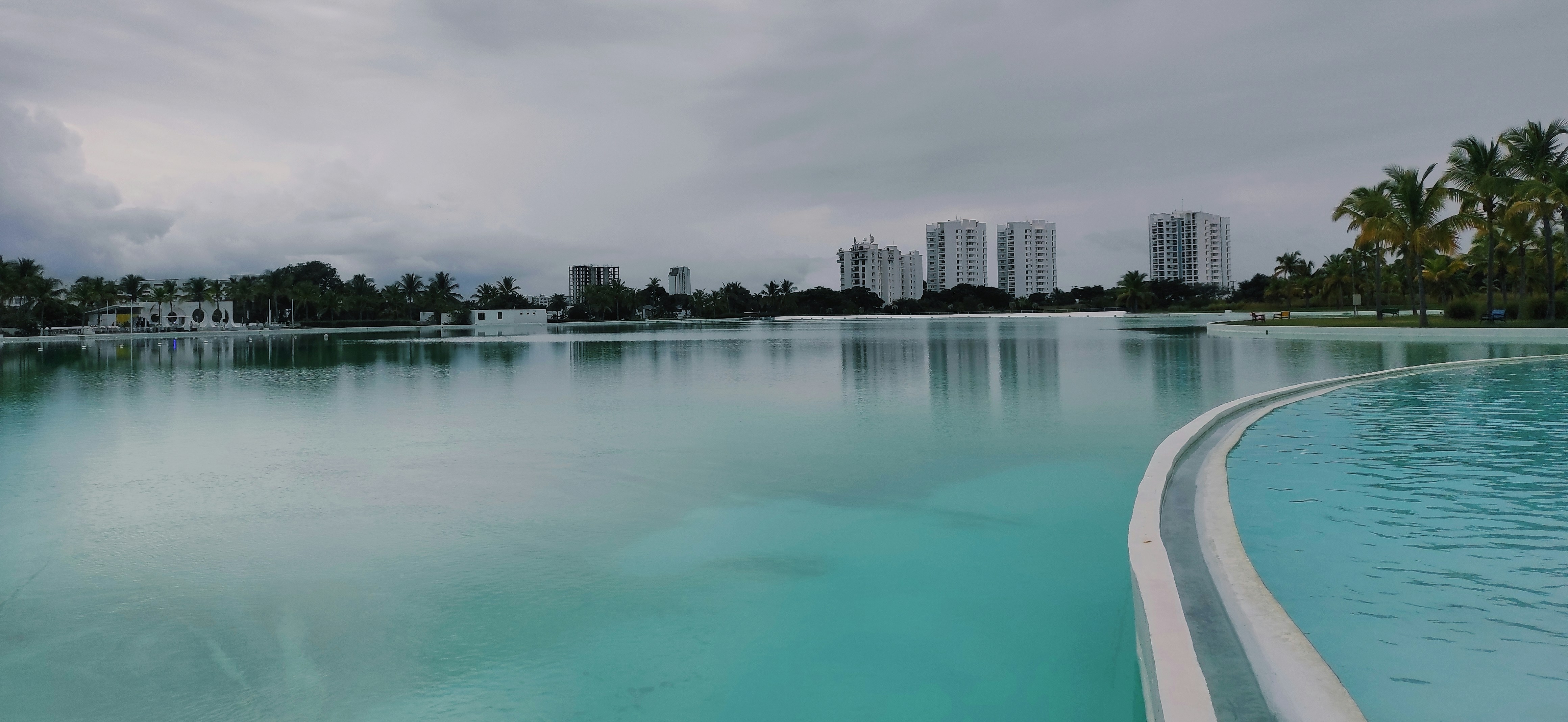 a large body of water with buildings in the background, 