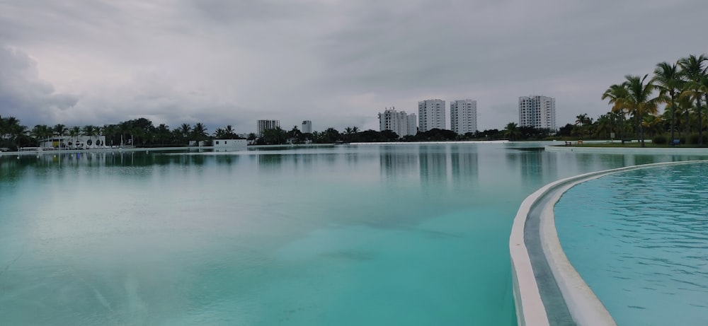 a large body of water with buildings in the background