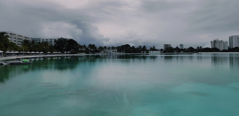 a large body of water with buildings in the background