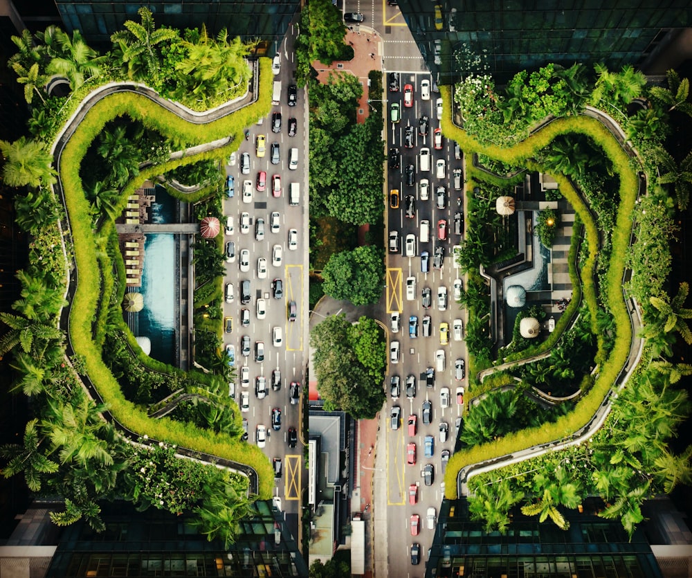 an aerial view of a city street with cars and trees