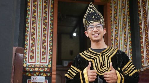 Smiling visitor receiving visa approval confirmation from an ISS Guyana representative.