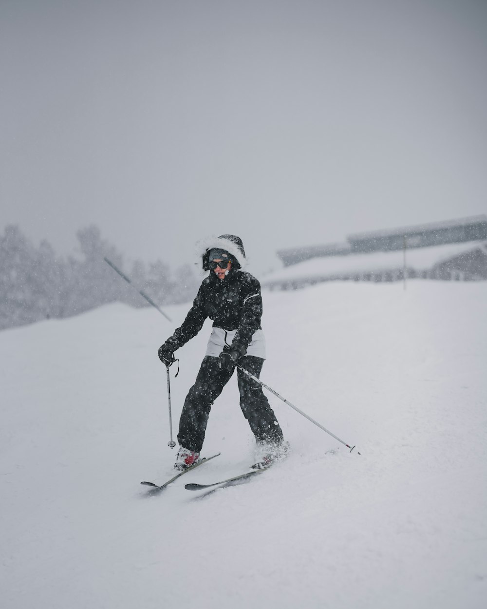 a man riding skis down a snow covered slope