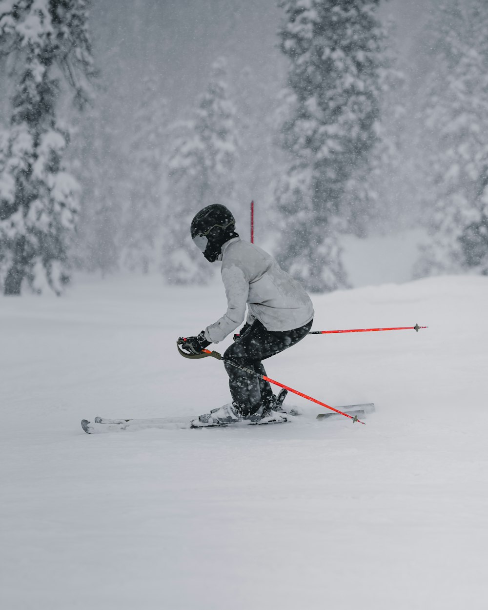 a person riding skis down a snow covered slope