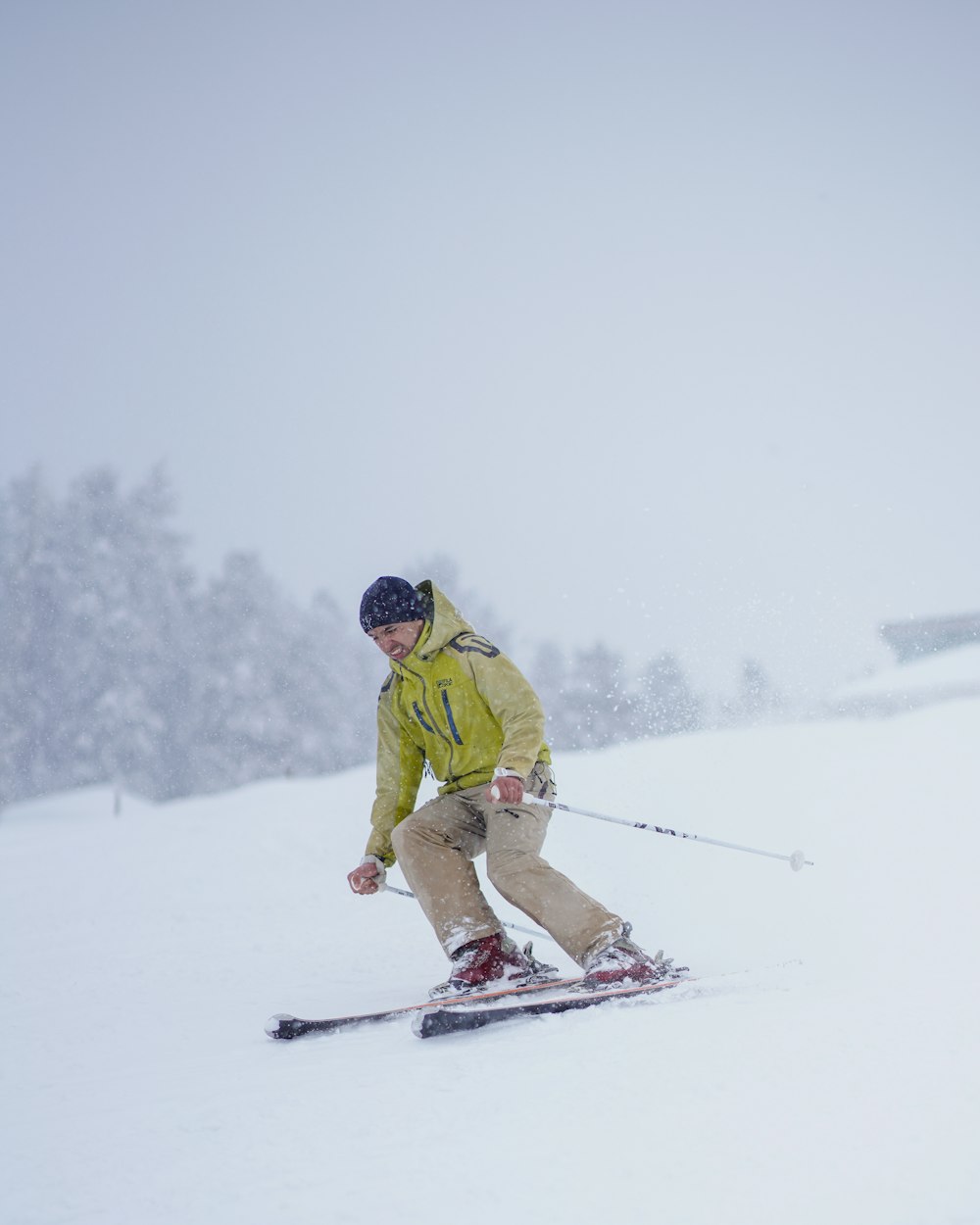 a man riding skis down a snow covered slope