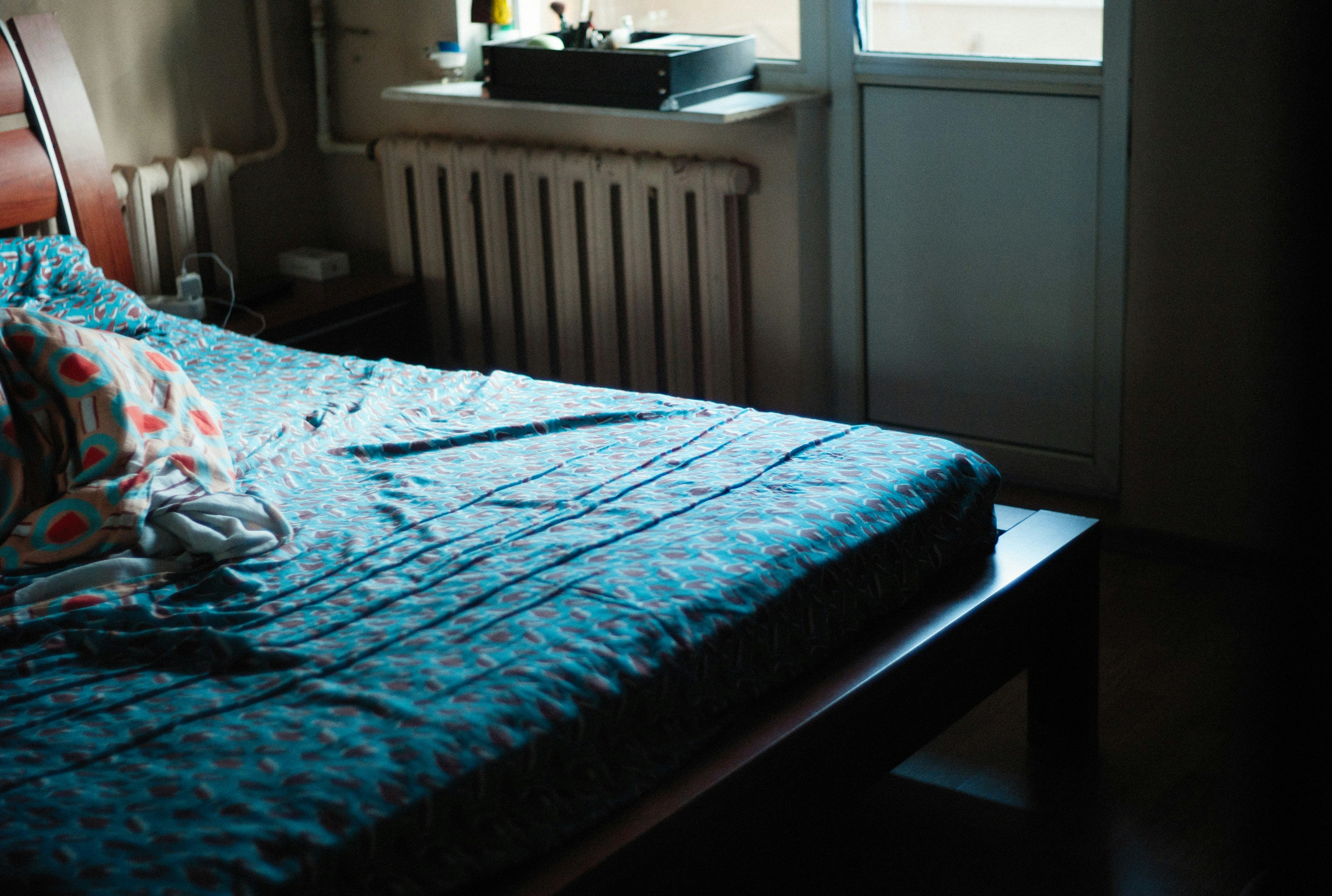 a bedroom with a bed and a window