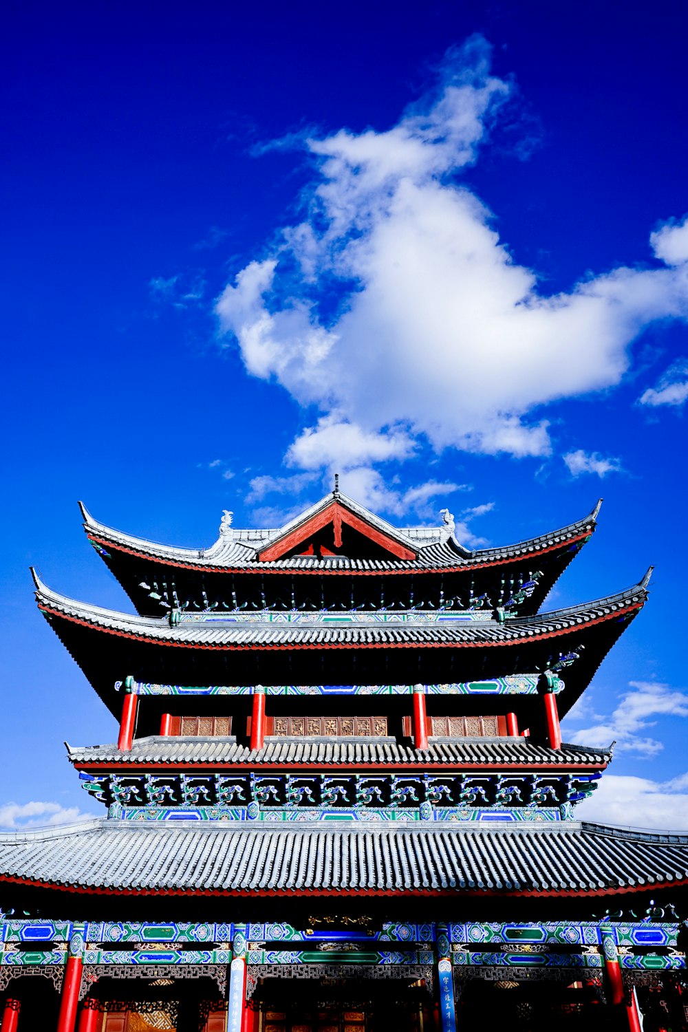 a tall building sitting under a blue sky