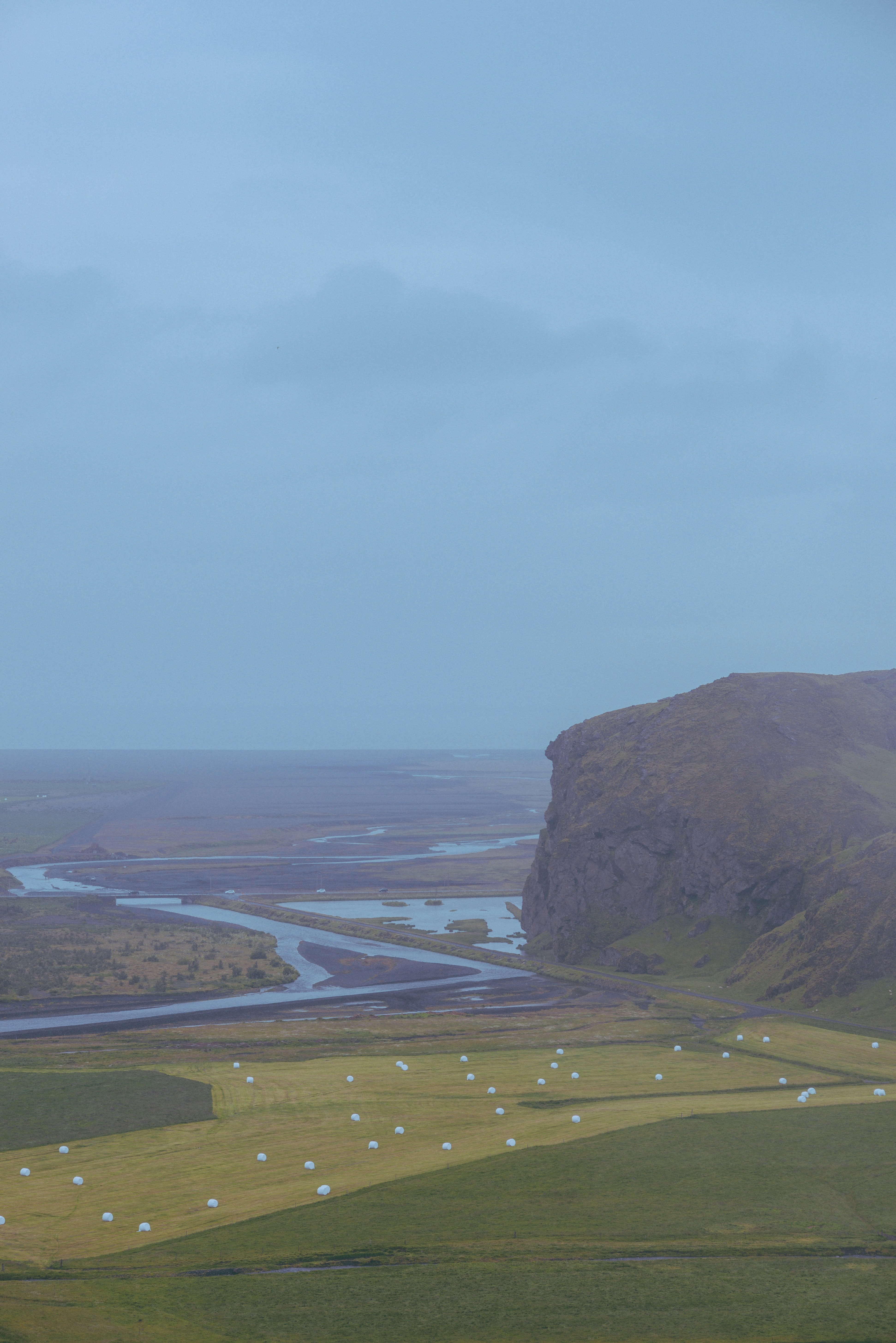 a hill with a river in the distance