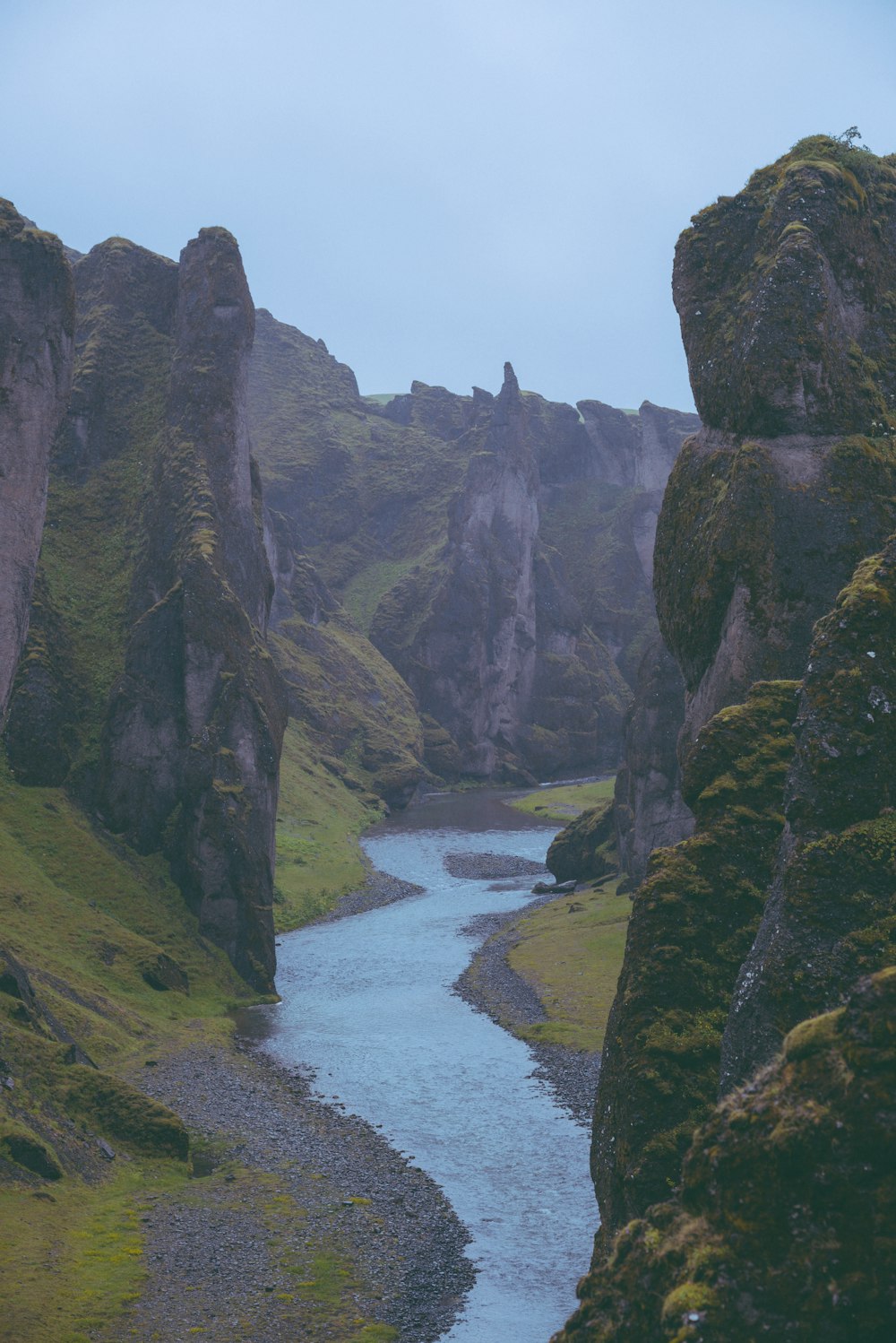 a river running through a lush green valley